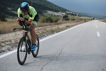 Image showing triathlon athlete riding bike