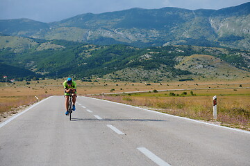 Image showing triathlon athlete riding bike