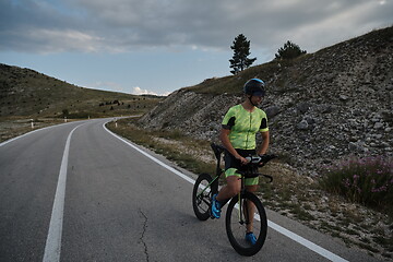 Image showing triathlon athlete riding bike