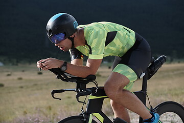 Image showing triathlon athlete riding bike