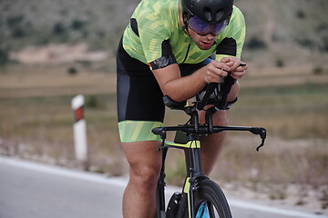 Image showing triathlon athlete riding bike