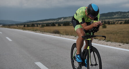 Image showing triathlon athlete riding bike