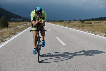 Image showing triathlon athlete riding bike