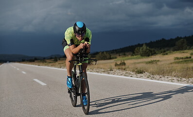 Image showing triathlon athlete riding bike