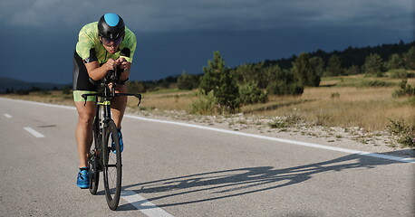 Image showing triathlon athlete riding bike