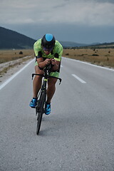 Image showing triathlon athlete riding bike