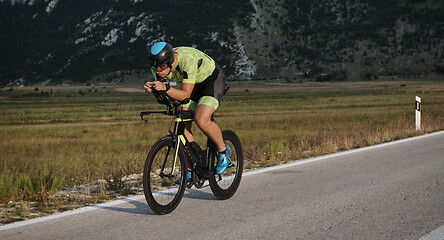 Image showing triathlon athlete riding bike