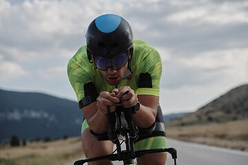 Image showing triathlon athlete riding bike