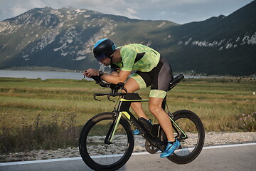 Image showing triathlon athlete riding bike