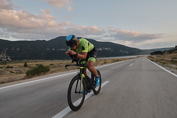 Image showing triathlon athlete riding bike