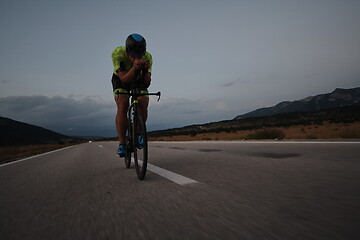 Image showing triathlon athlete riding bike