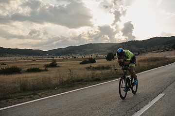 Image showing triathlon athlete riding bike