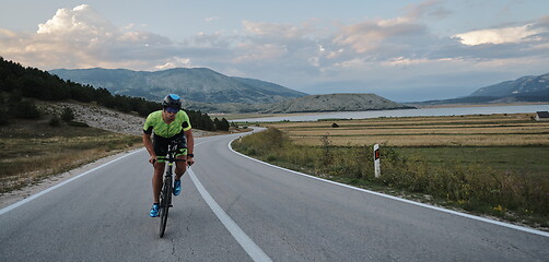 Image showing triathlon athlete riding bike