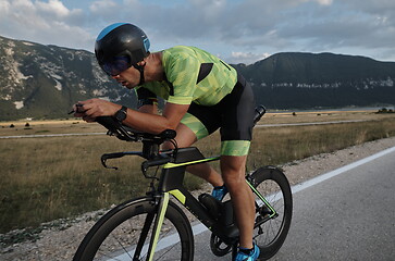 Image showing triathlon athlete riding bike