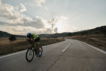 Image showing triathlon athlete riding bike