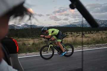 Image showing cinematographer taking action shot of triathlon bike athlete