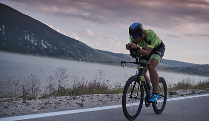 Image showing triathlon athlete riding bike