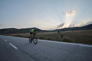 Image showing triathlon athlete riding bike