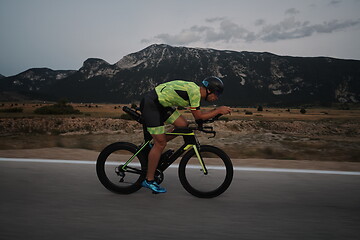 Image showing triathlon athlete riding bike