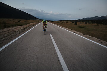 Image showing triathlon athlete riding bike