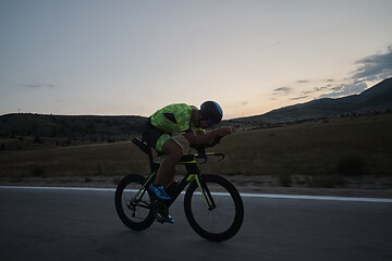 Image showing triathlon athlete riding bike