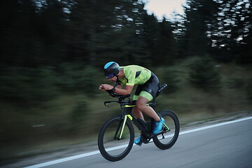 Image showing triathlon athlete riding bike at night