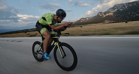 Image showing triathlon athlete riding bike