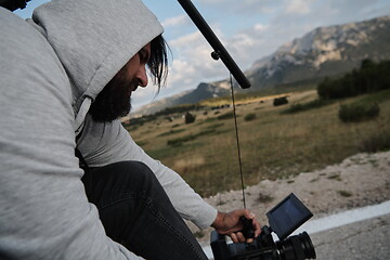 Image showing cinematographer taking action shot of triathlon bike athlete