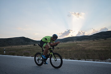 Image showing triathlon athlete riding bike