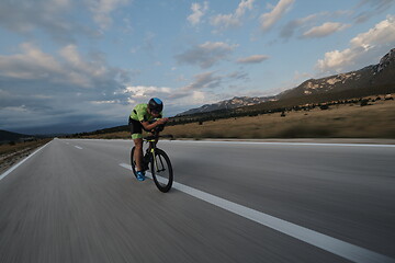 Image showing triathlon athlete riding bike