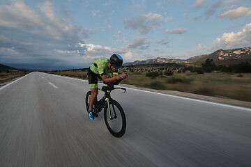 Image showing triathlon athlete riding bike