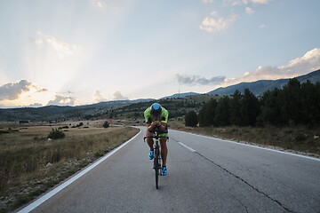 Image showing triathlon athlete riding bike