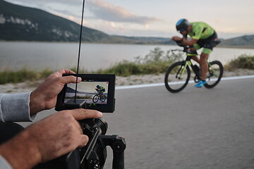 Image showing cinematographer taking action shot of triathlon bike athlete