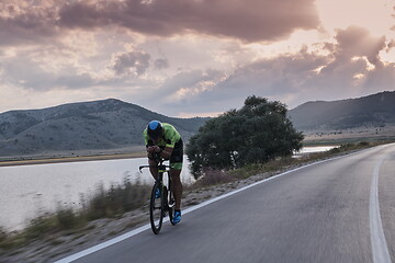 Image showing triathlon athlete riding bike