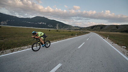 Image showing triathlon athlete riding bike