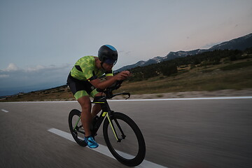 Image showing triathlon athlete riding bike