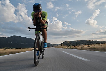 Image showing triathlon athlete riding bike