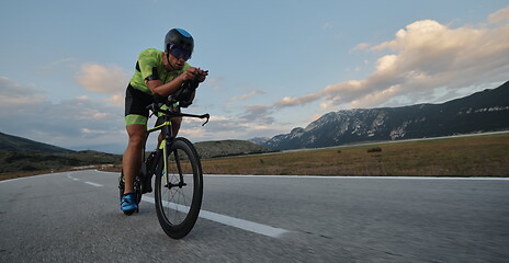 Image showing triathlon athlete riding bike