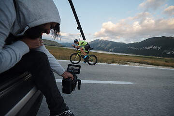 Image showing cinematographer taking action shot of triathlon bike athlete