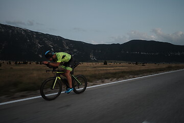 Image showing triathlon athlete riding bike