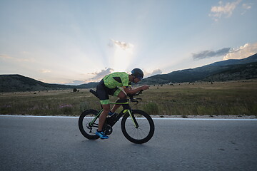 Image showing triathlon athlete riding bike