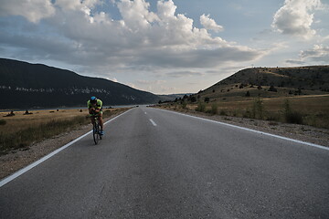 Image showing triathlon athlete riding bike