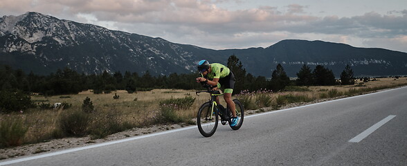 Image showing triathlon athlete riding bike