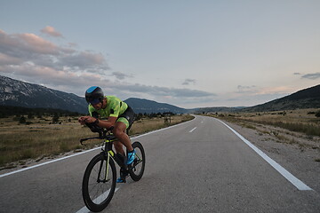 Image showing triathlon athlete riding bike