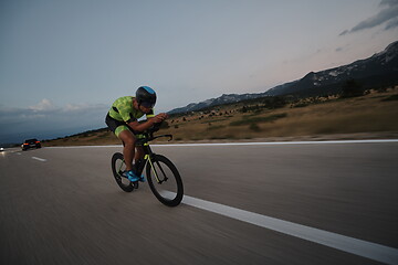 Image showing triathlon athlete riding bike