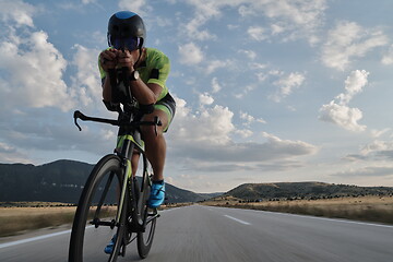 Image showing triathlon athlete riding bike