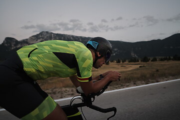 Image showing triathlon athlete riding bike