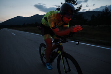 Image showing triathlon athlete riding bike at night