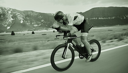 Image showing triathlon athlete riding bike