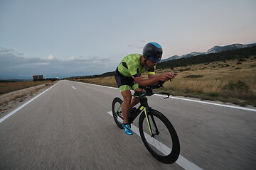 Image showing triathlon athlete riding bike